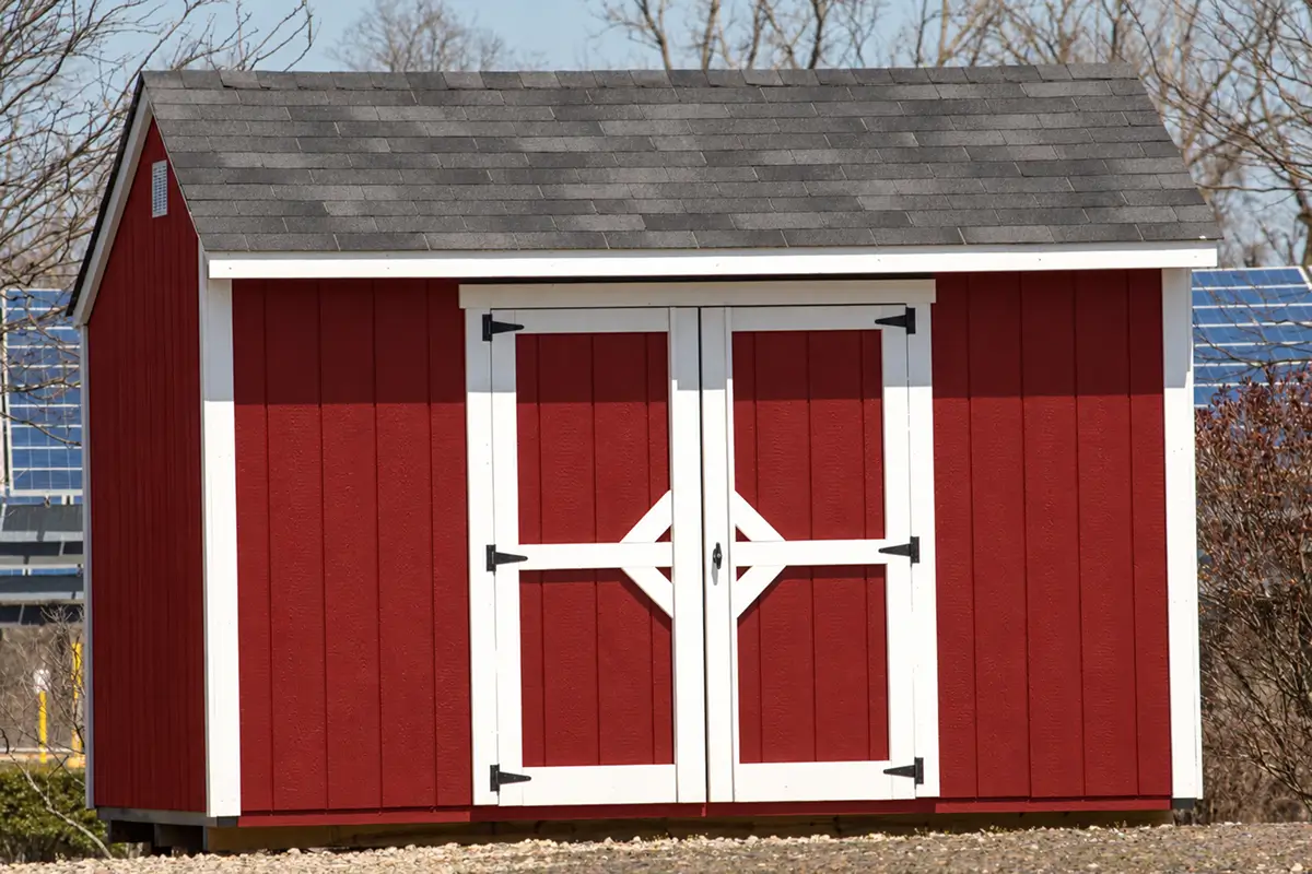 Red backyard shed with white trim